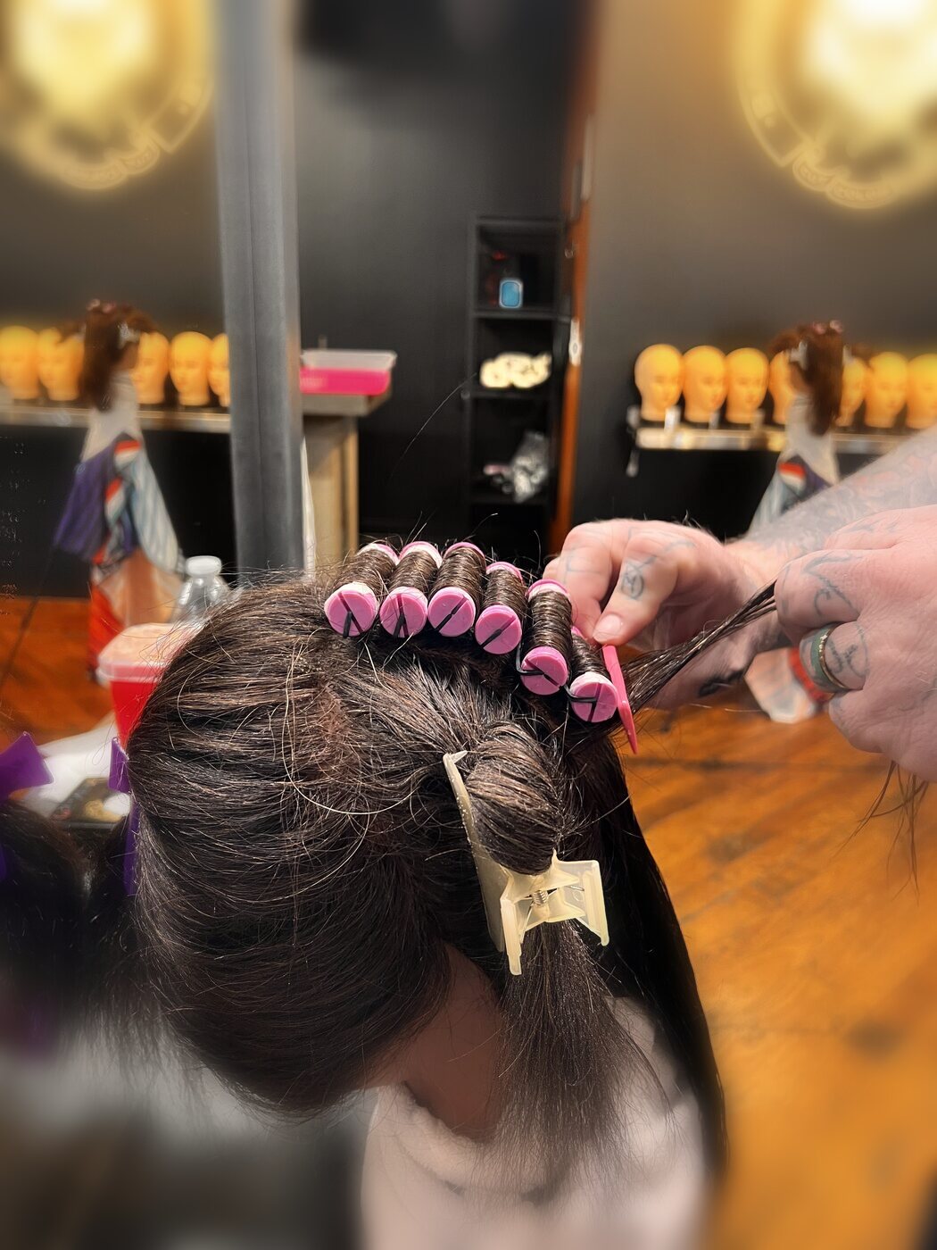 Perm-rod texture work on campus beneath the Bareknuckle Hair Institute seal