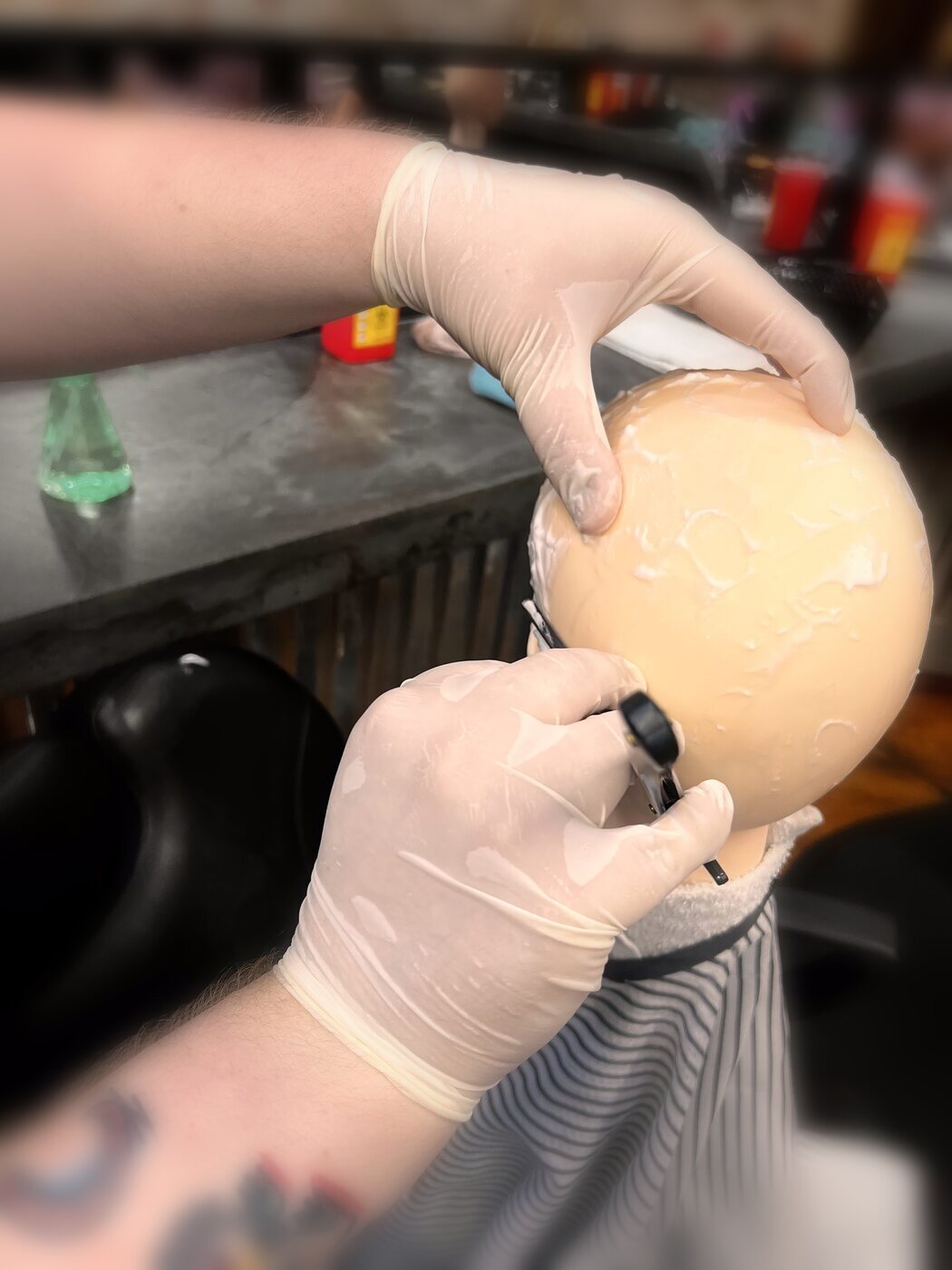 Student applying texture treatment with classmates working behind